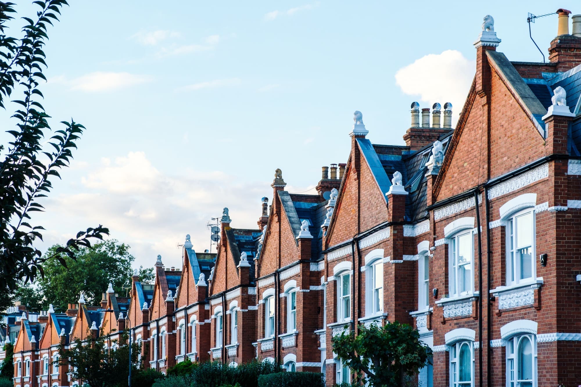 Terraced houses with red brick facade forming a residential street in london Terraced houses with red brick facade forming a residential street in london